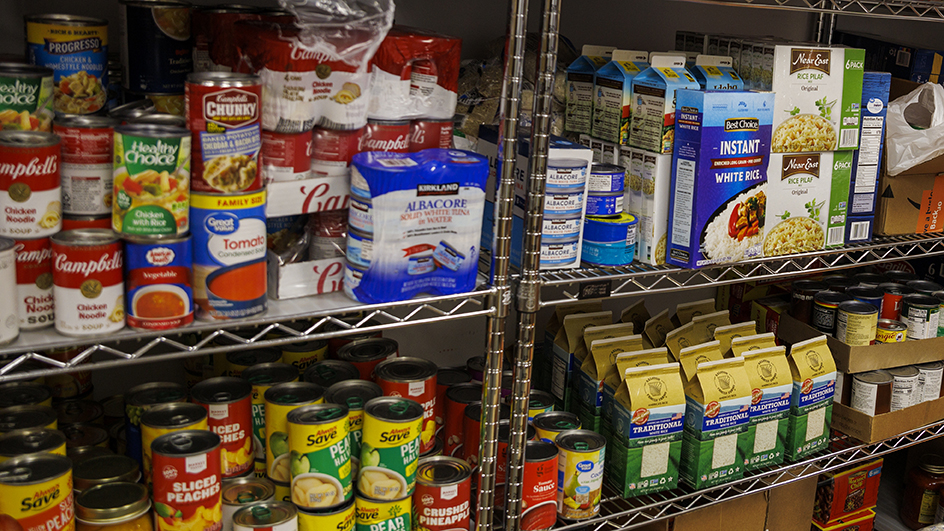 Canned and boxed food items on shelves inside Husker Pantry.