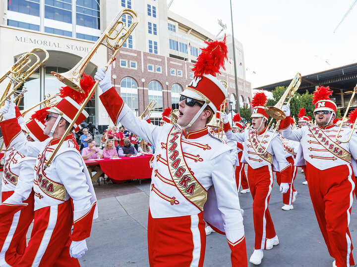 The Cornhusker Marching Band shows their spirti as they march past the judges table in front of Memorial Stadium. Homecoming Parade and Cornstalk. September 30, 2022. Photo by Craig Chandler / University Communication.