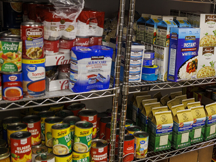 Canned and boxed food items on shelves inside Husker Pantry.