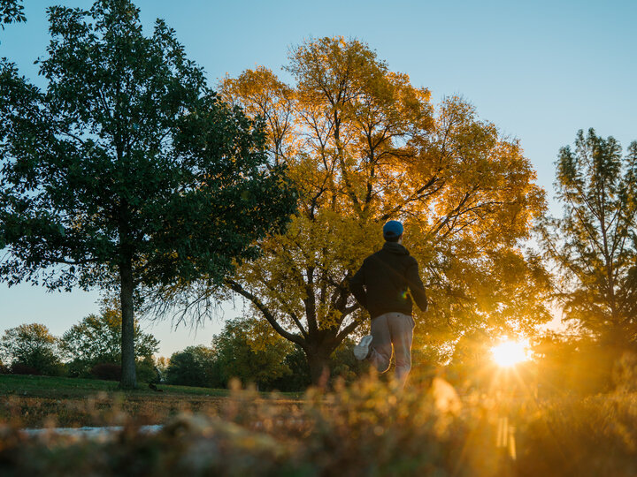 Person runs as the sun rises