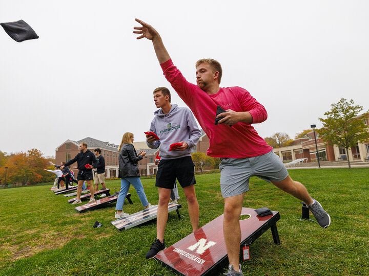 Brayan Van Meter throws a bag as he competes for Phi Delta Theta. Cornhole Tournament for Homecoming. October 25, 2023. [Photo by Craig Chandler / University Communication]